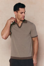 Man in Antonio brown/beige striped linen polo with open collar and contrast trim.