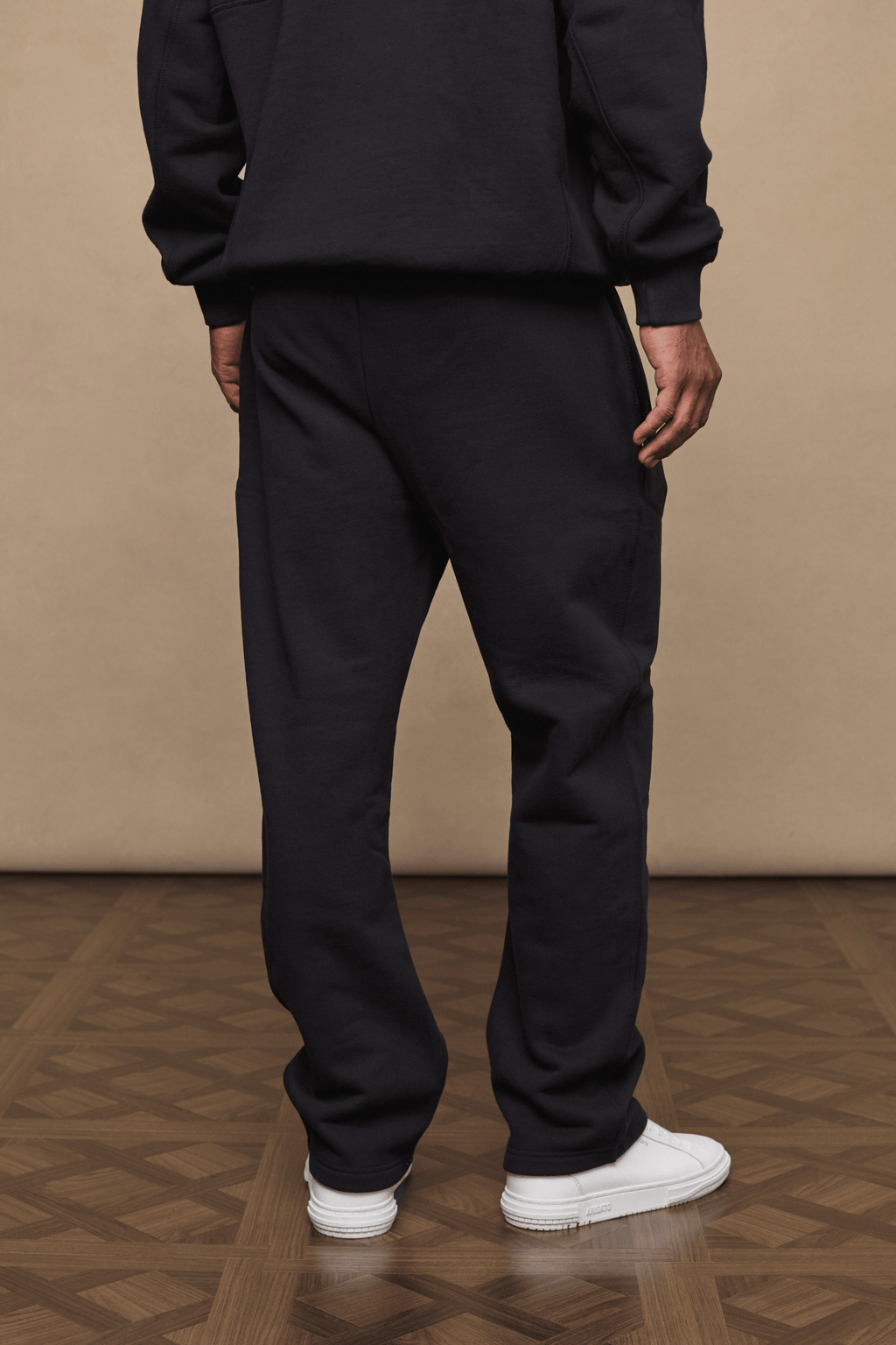 Black Axel straight leg jogger with soft fleece lining, worn by a person from behind.
