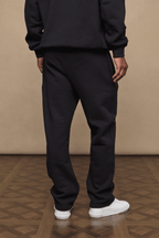 Black Axel straight leg jogger with soft fleece lining, worn by a person from behind.