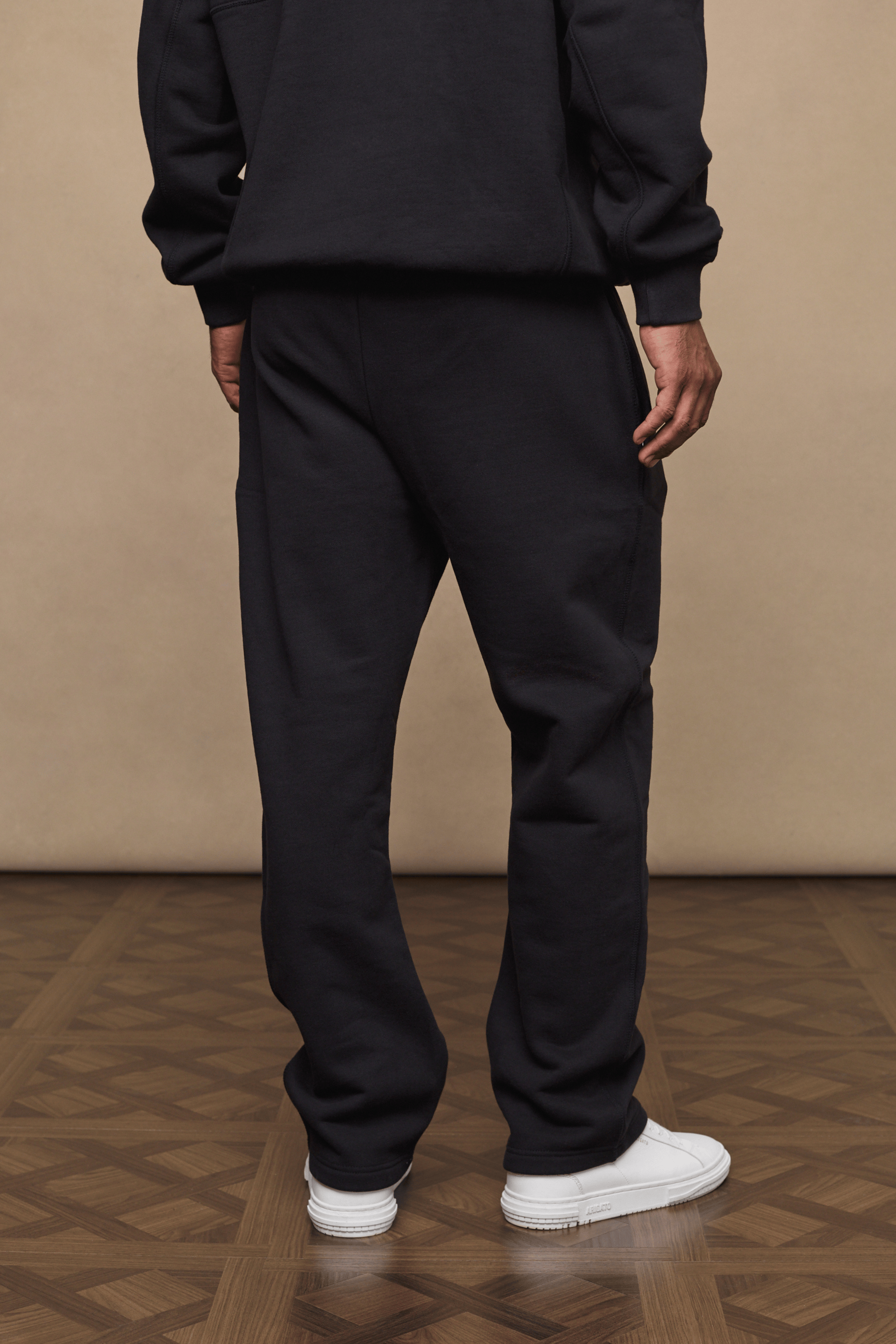 Black Axel straight leg jogger with soft fleece lining, worn by a person from behind.