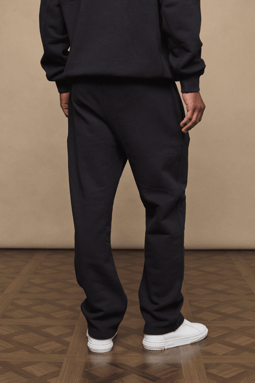 Black Axel straight leg jogger with soft fleece lining, worn by a person from behind.