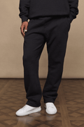 Black Axel straight leg joggers made from heavyweight cotton-polyester blend, worn with white sneakers.