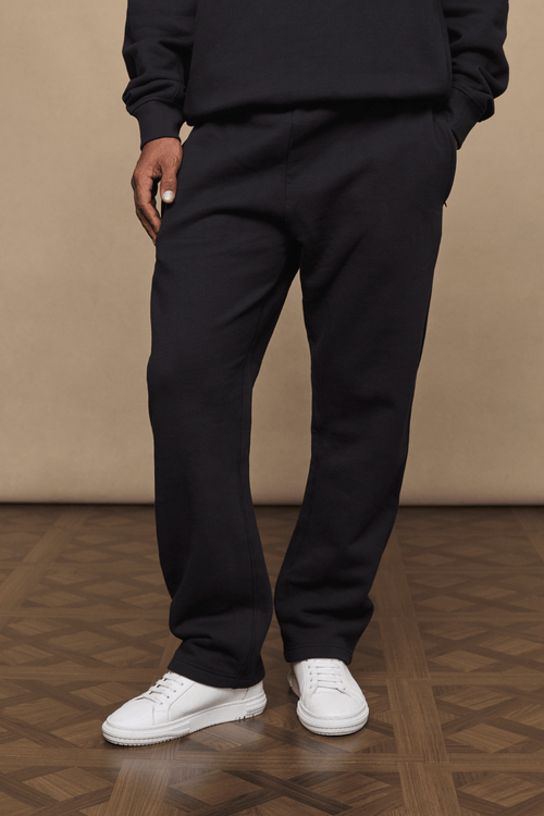 Black Axel straight leg joggers made from heavyweight cotton-polyester blend, worn with white sneakers.