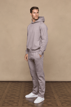 Man wearing a brown marl Axel Straight Leg Jogger and matching hoodie, with white sneakers.
