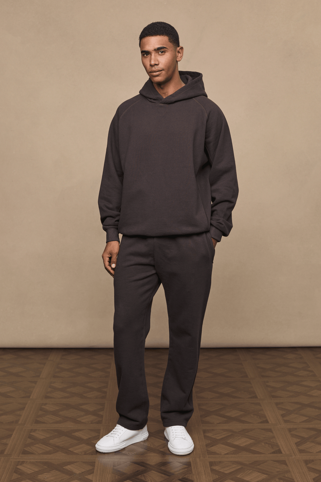 Man wearing dark brown Axel straight leg joggers and matching hoodie.