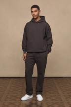 Man wearing dark brown Axel straight leg joggers and matching hoodie.