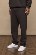Dark brown Axel straight leg jogger and matching hoodie on a person, paired with white sneakers.