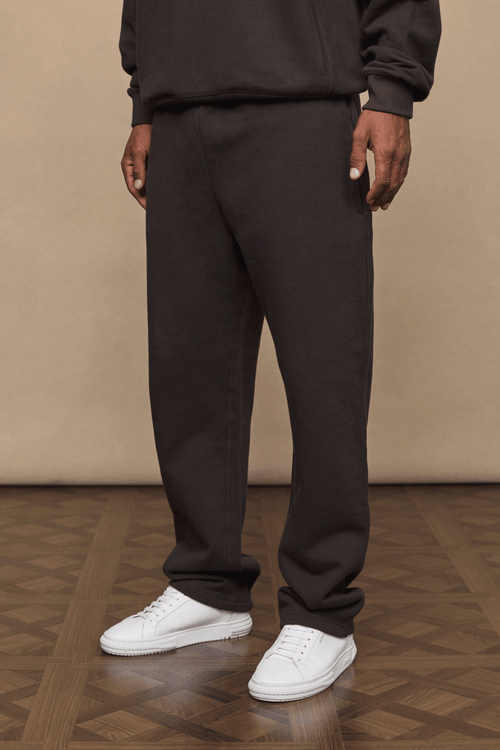 Dark brown Axel straight leg jogger and matching hoodie on a person, paired with white sneakers.