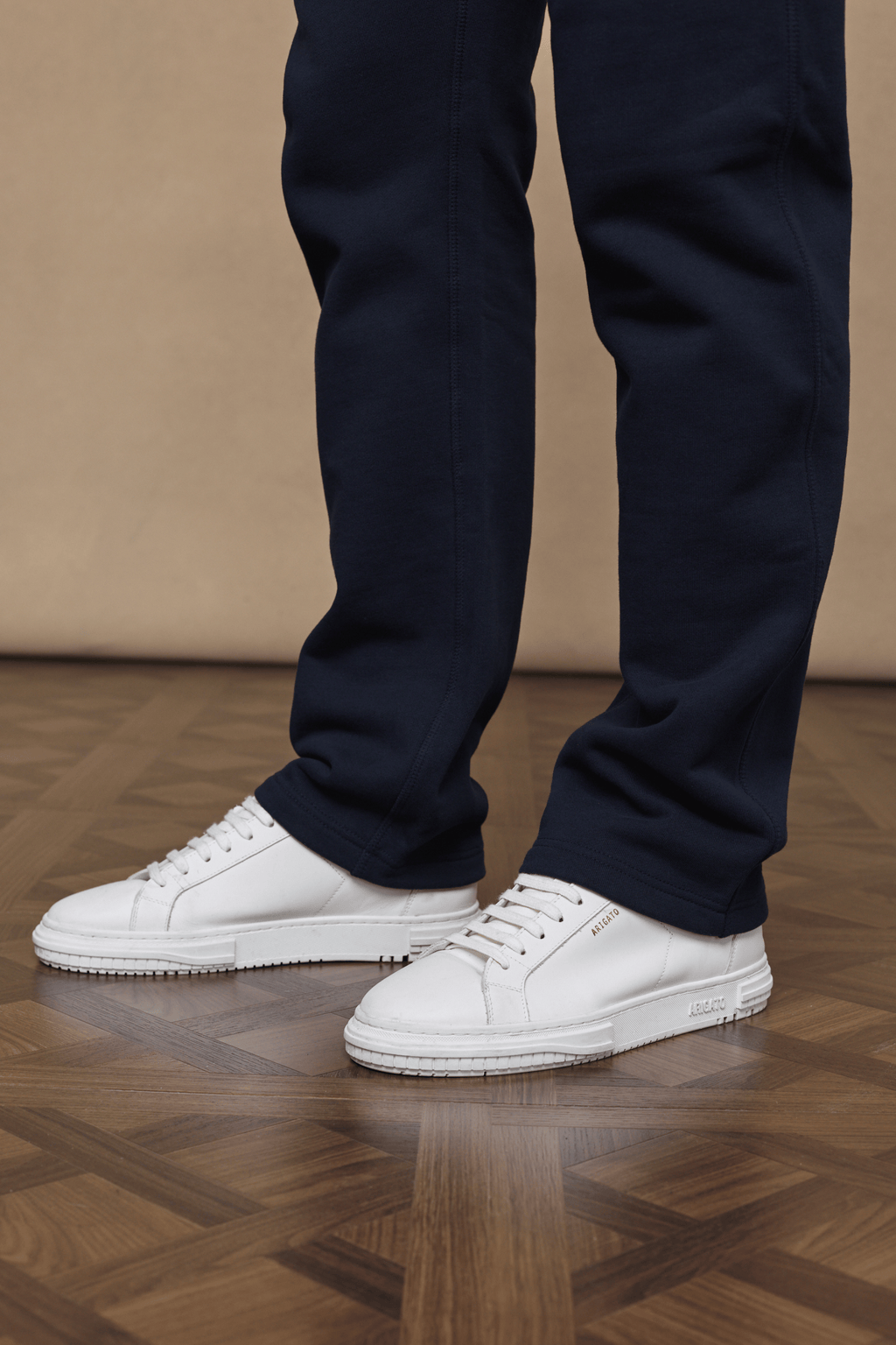 Dark navy Axel straight leg joggers made from heavyweight cotton-blend fleece, paired with white sneakers.