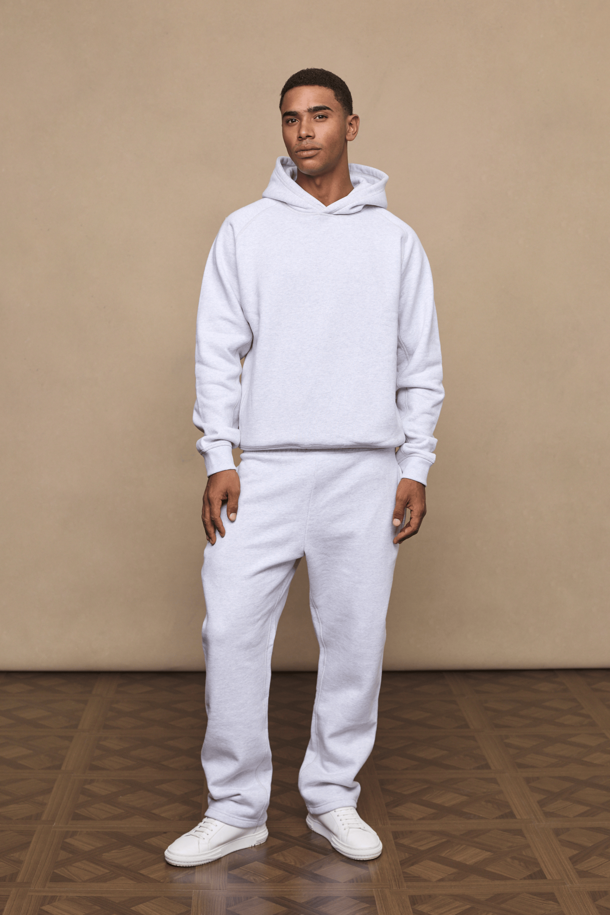 Man wearing a stone marl Axel straight leg jogger and matching hoodie, showcasing the relaxed fit.