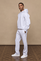 Man wearing Axel Straight Leg Jogger in Stone Marl with matching hoodie and white sneakers.