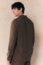 Man wearing a relaxed fit brown Cami Linen Classic Collar Shirt, shown from the back.