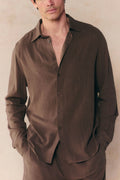 Man wearing a brown Cami Linen Classic Collar Shirt with long sleeves, relaxed fit, and open top button.