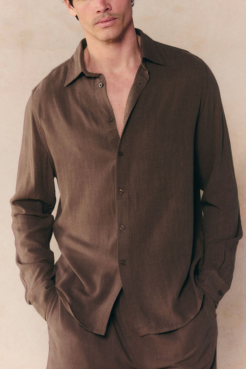 Man wearing a brown Cami Linen Classic Collar Shirt with long sleeves, relaxed fit, and open top button.