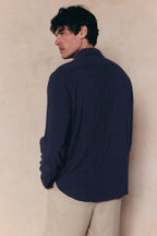Man wearing a navy Cami Linen Classic Collar Shirt with a relaxed fit, natural texture, and standard collar.