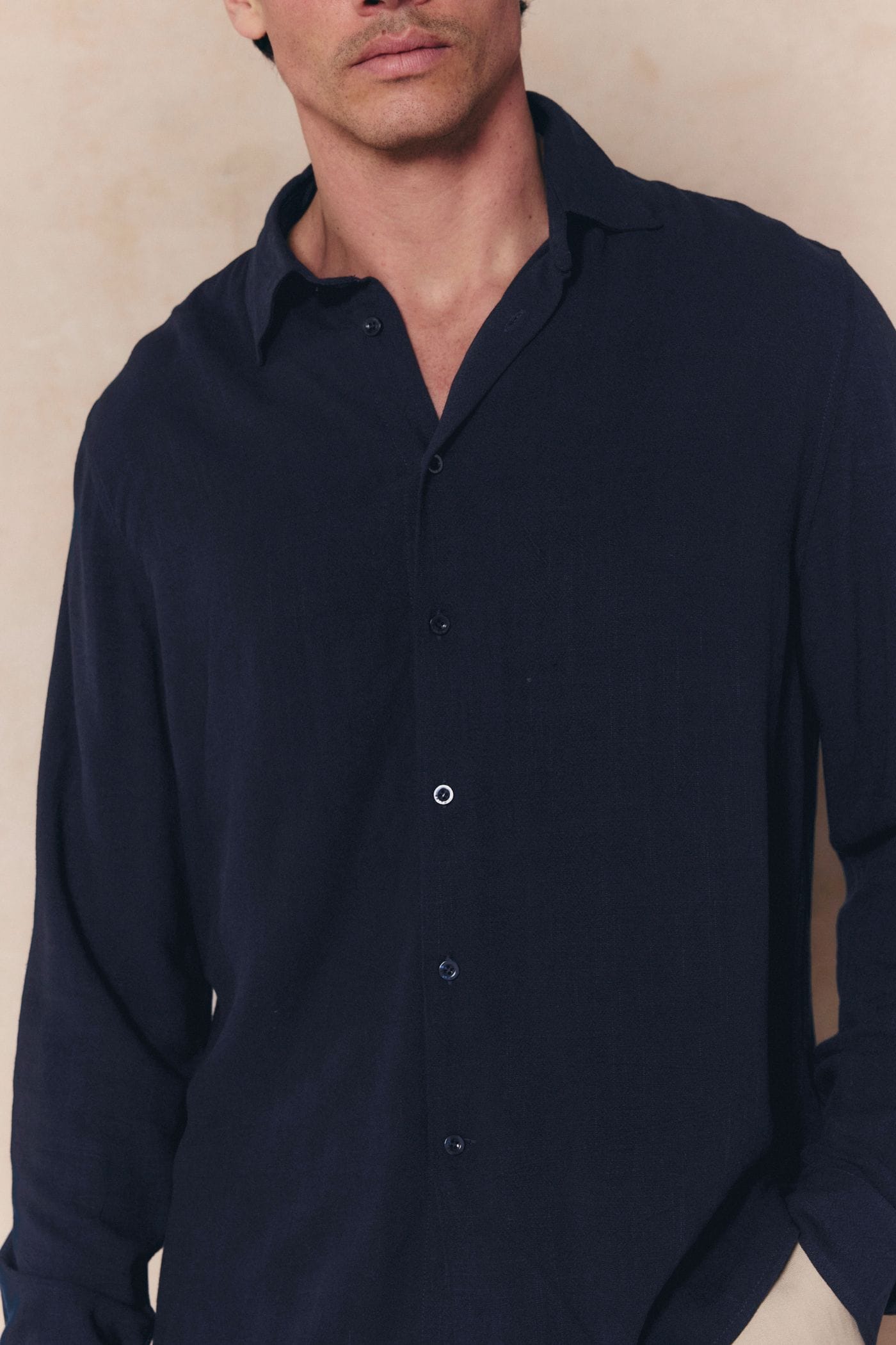 Man wearing a navy Cami Linen Classic Collar Shirt with a relaxed fit and natural texture.