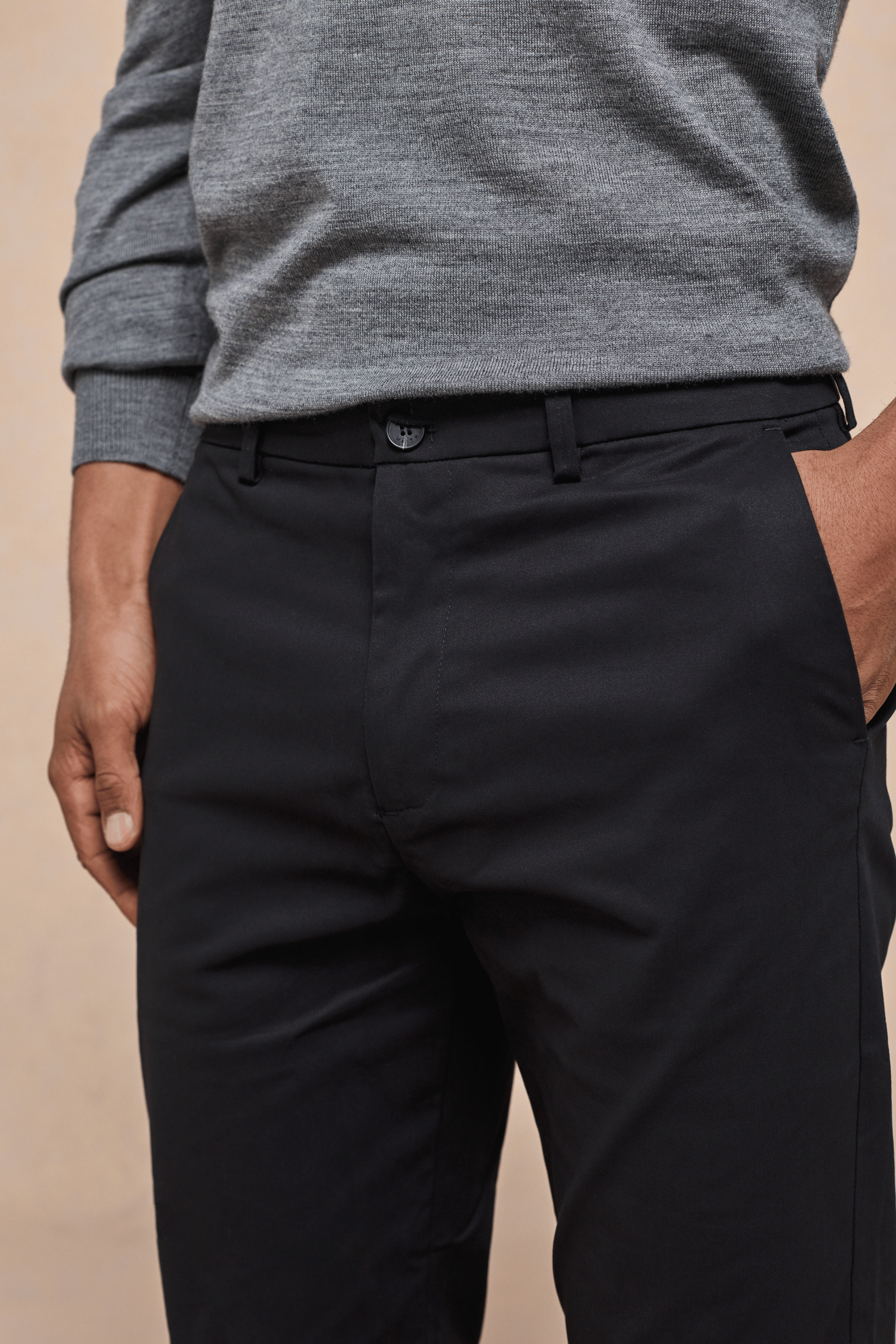 Black Elliot Easy Chino pants with faux horn button, belt loops, and side pockets, worn with a grey sweater.