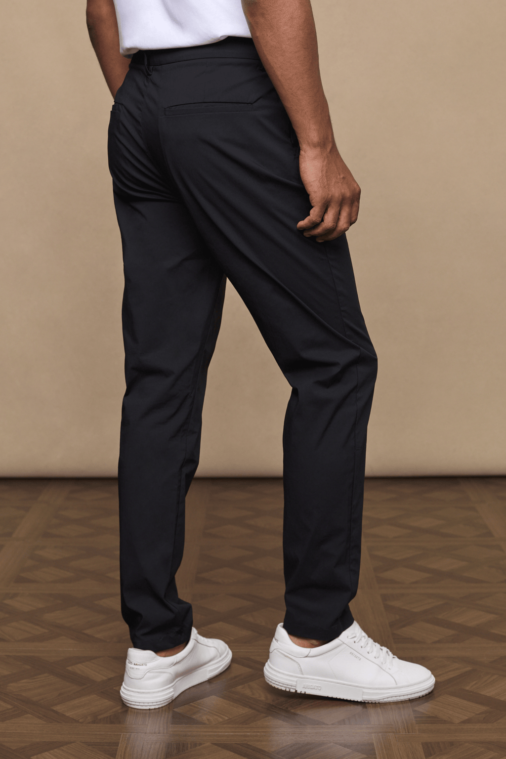 Man wearing black Enzo Hybrid Trousers made from lightweight 4-way stretch fabric, showing side entry pockets.