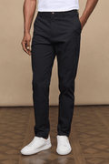 Man wearing black Enzo Hybrid Trousers with branded popper buttons, belt loops, and side pockets.