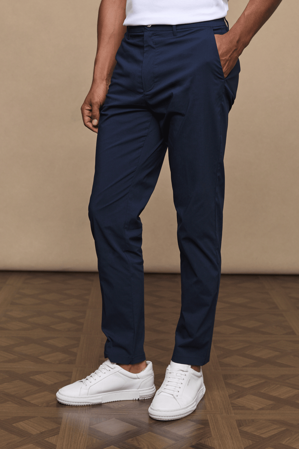 Man wearing dark navy Enzo Hybrid Trousers made from lightweight 4-way stretch fabric, featuring side pockets and a clean, modern silhouette.