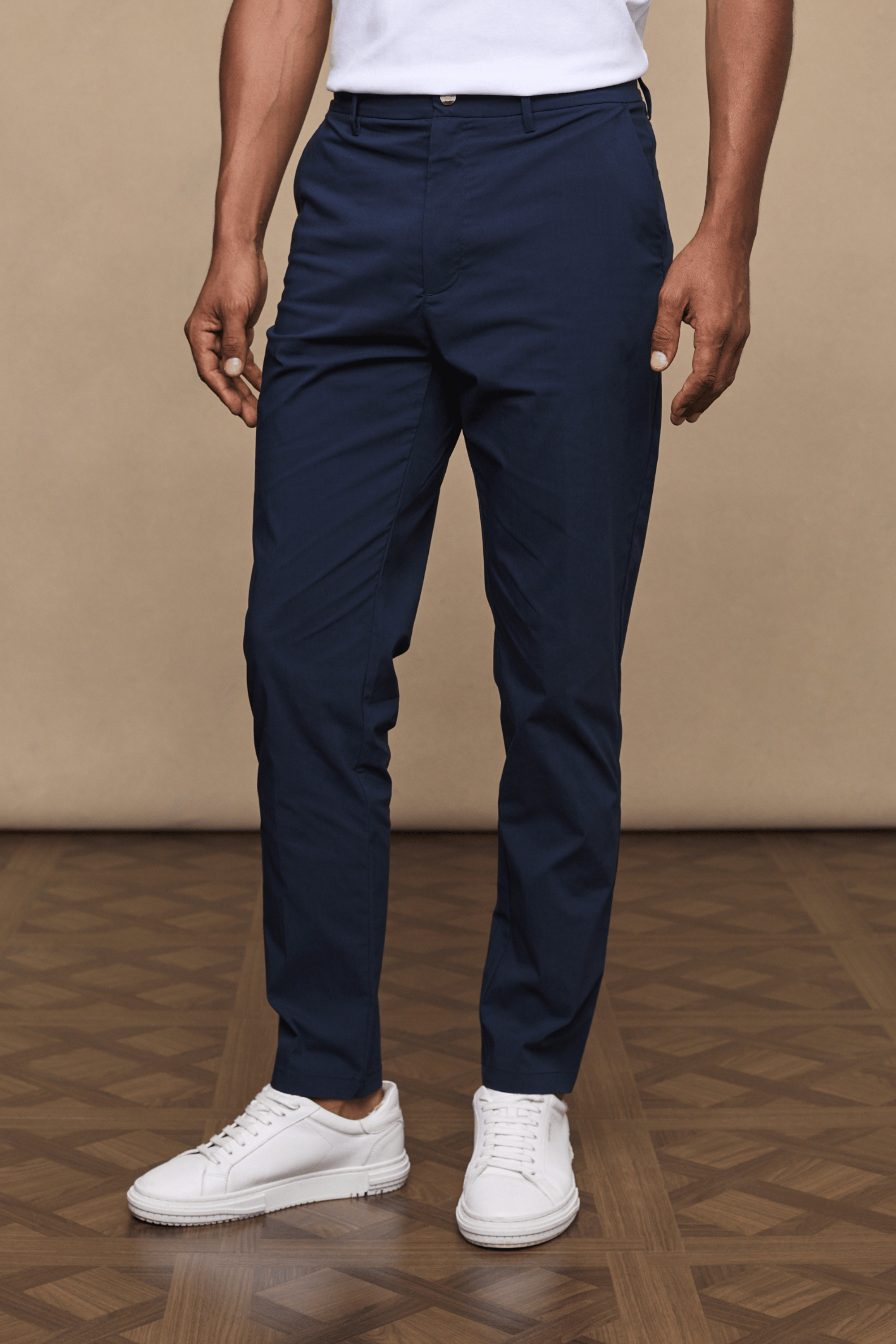 Dark navy Enzo Hybrid Trouser on a man, showcasing 4-way stretch fabric, belt loops, and a clean, modern silhouette.