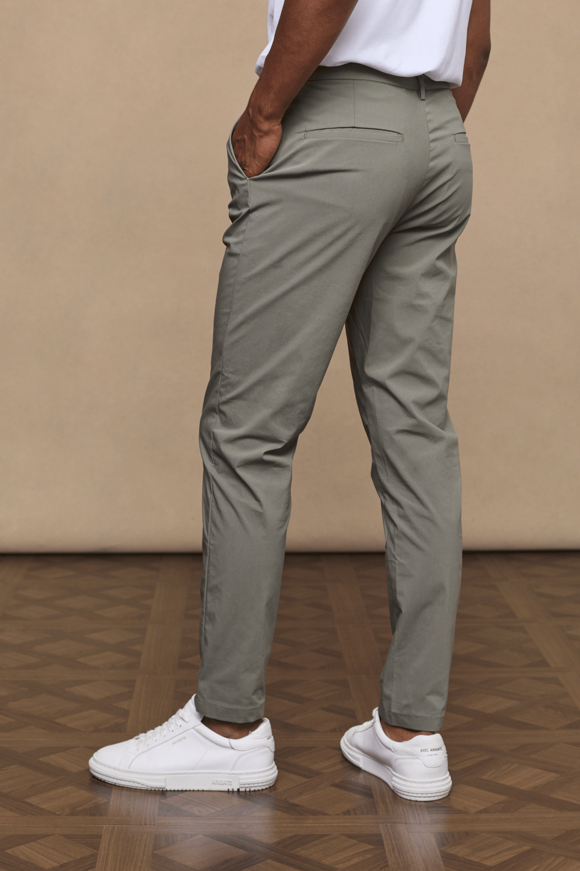 Man wearing dark olive Enzo Hybrid Trousers made from lightweight 4-way stretch fabric, with side pockets and belt loops.