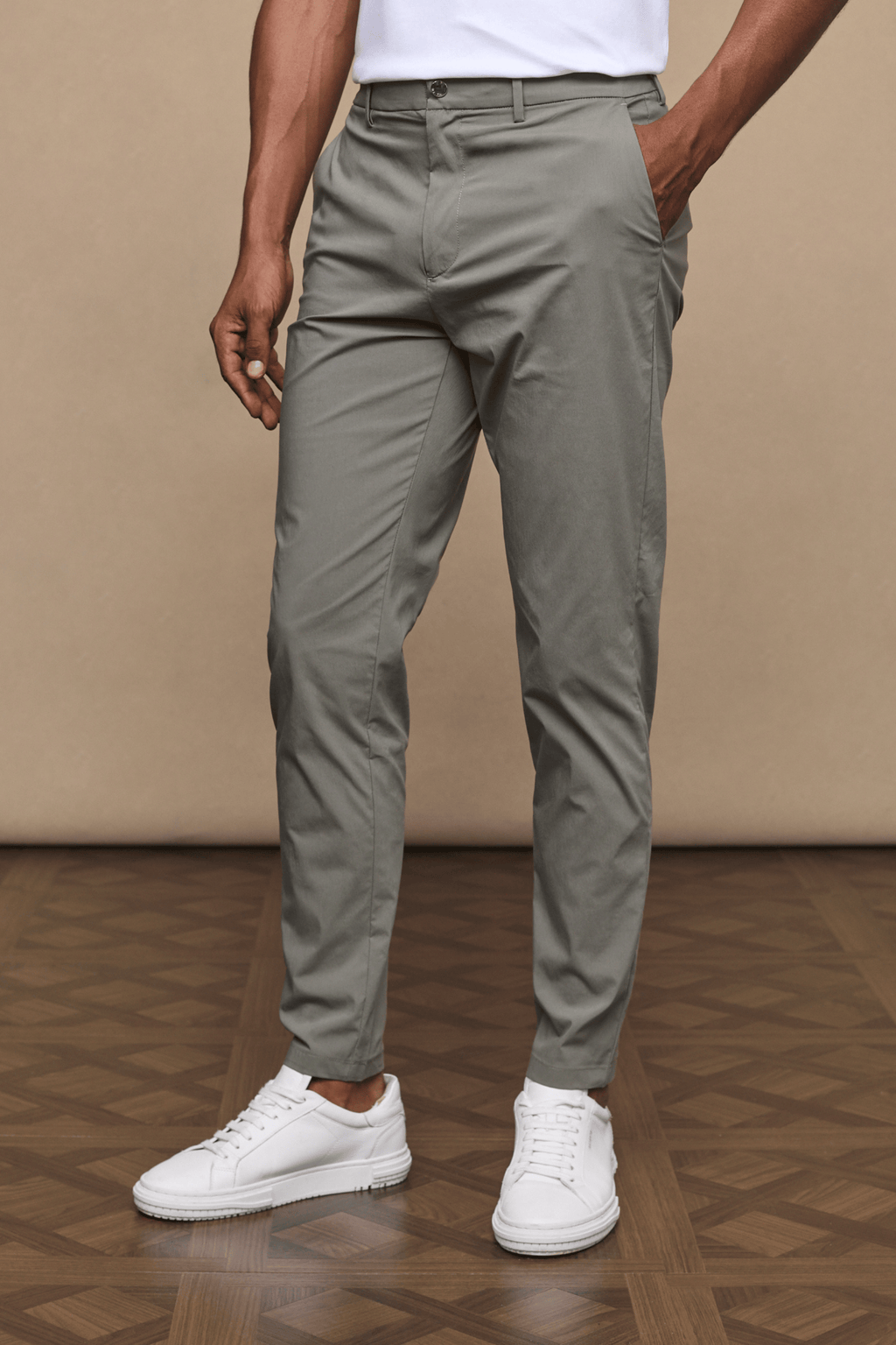 Man wearing dark olive Enzo Hybrid Trousers made from 4-way stretch fabric, with side pockets and belt loops.