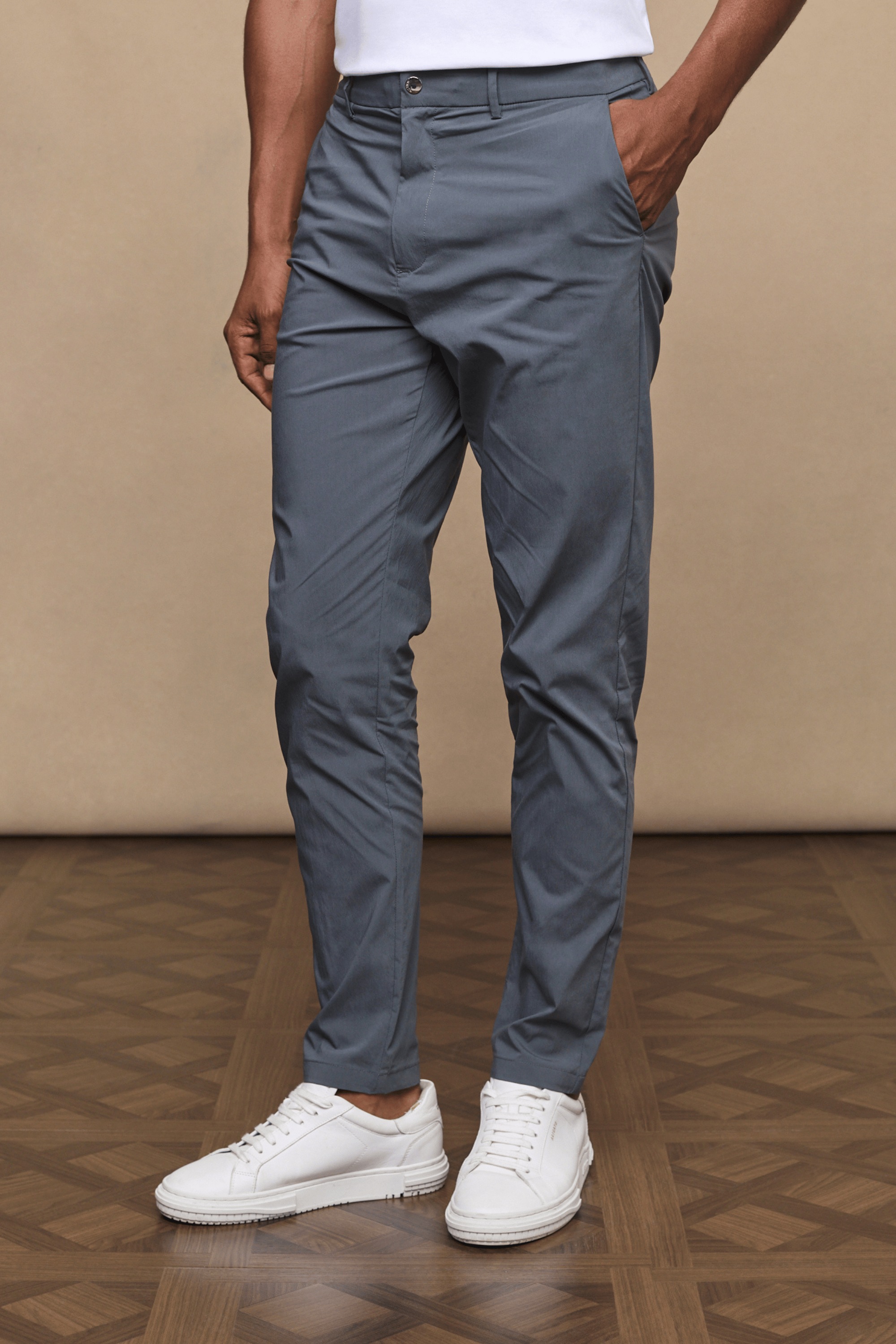 Man wearing slate Enzo Hybrid Trousers made from lightweight 4-way stretch fabric with side pockets.