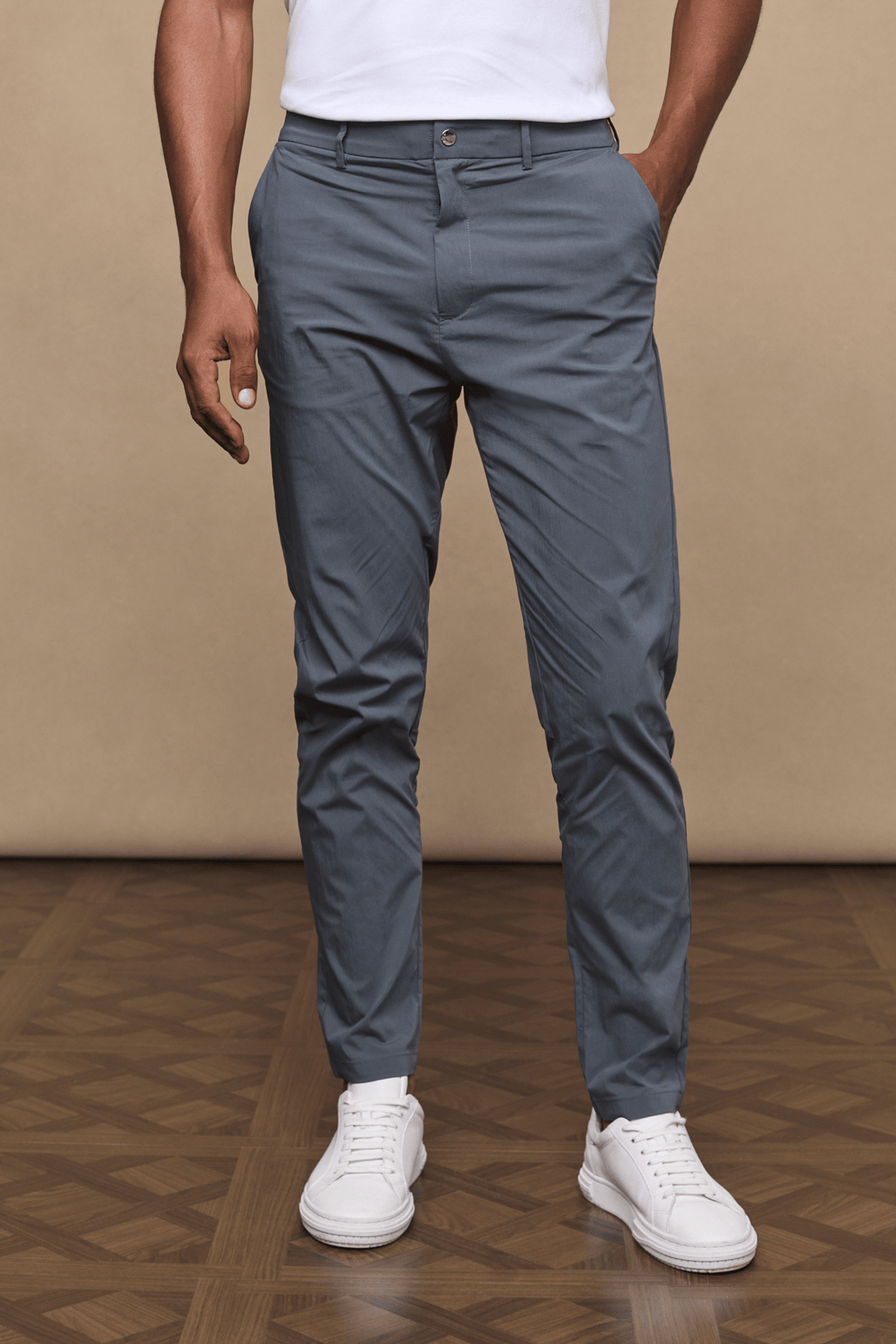 Man wearing slate Enzo Hybrid Trousers, a lightweight 4-way stretch fabric with belt loops and side pockets.