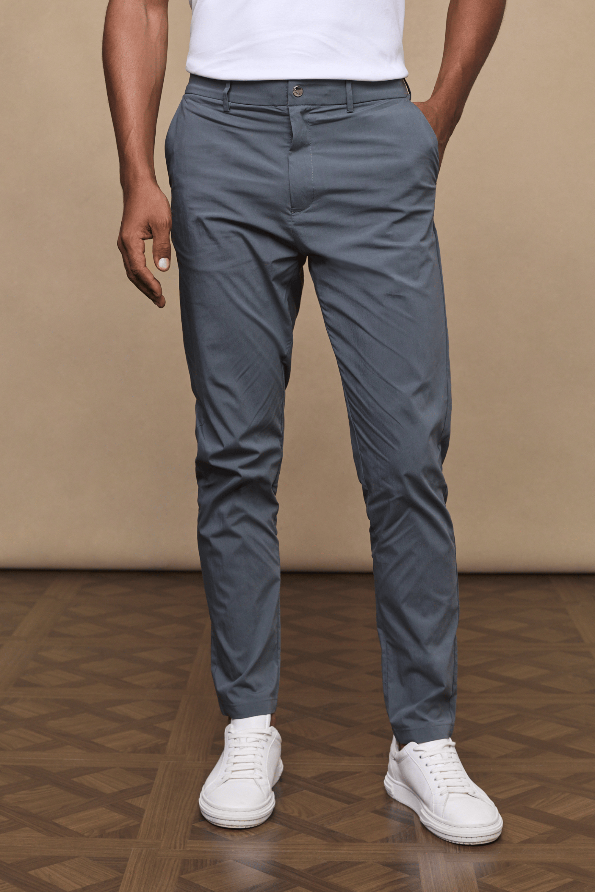 Man wearing slate Enzo Hybrid Trousers, a lightweight 4-way stretch fabric with belt loops and side pockets.
