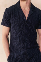 Navy Fausto Flocked Top, a short-sleeved towelling shirt with a unique textured pattern and open collar.