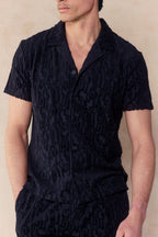Navy Fausto Flocked Top, a short-sleeved towelling shirt with a unique textured pattern and button-front closure.
