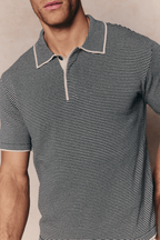Men's Felipe beige/black striped linen blend polo with concealed half placket and contrast hems.