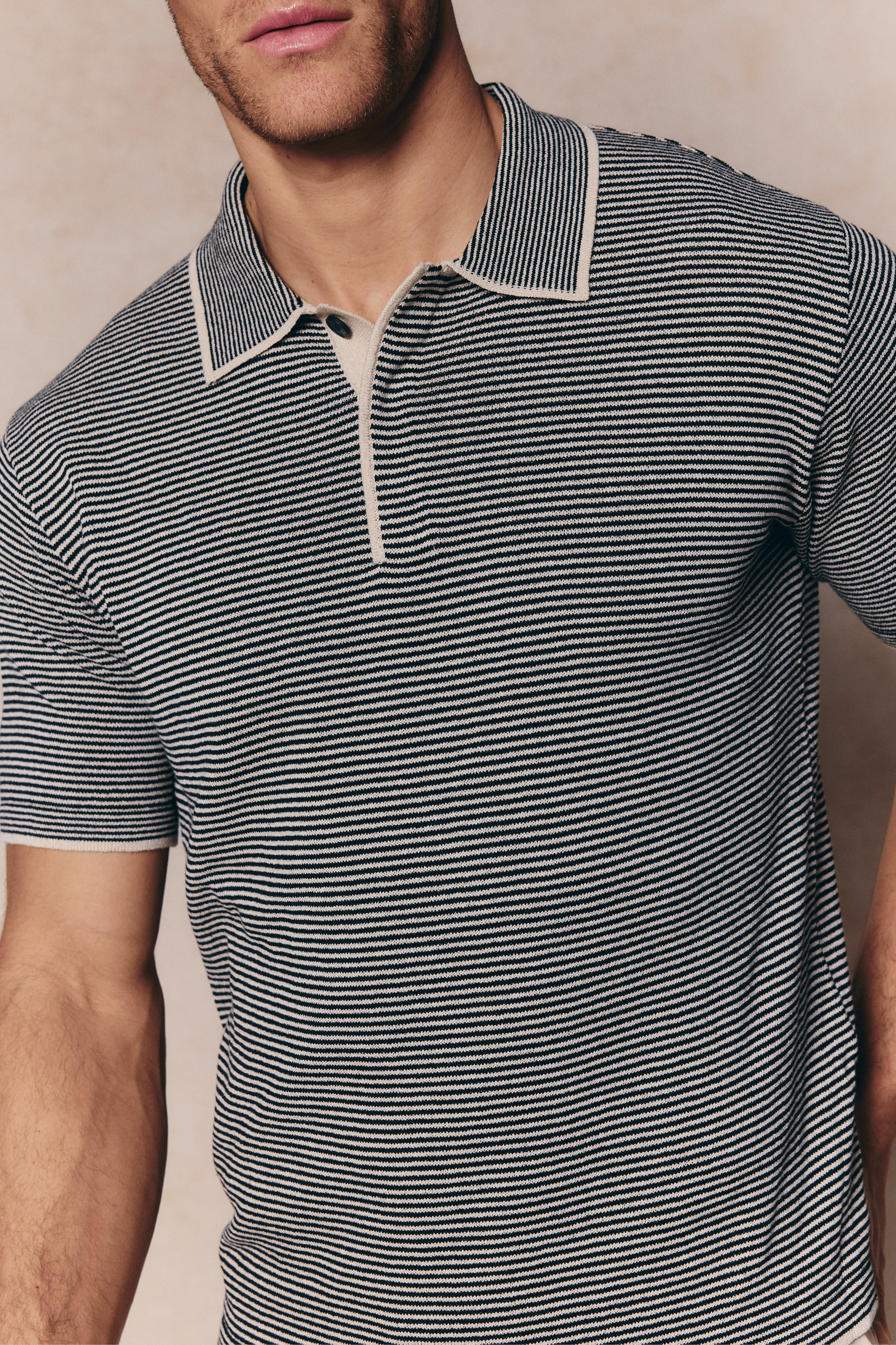 Men's Felipe beige/black striped linen blend polo with concealed half placket and contrast hems.