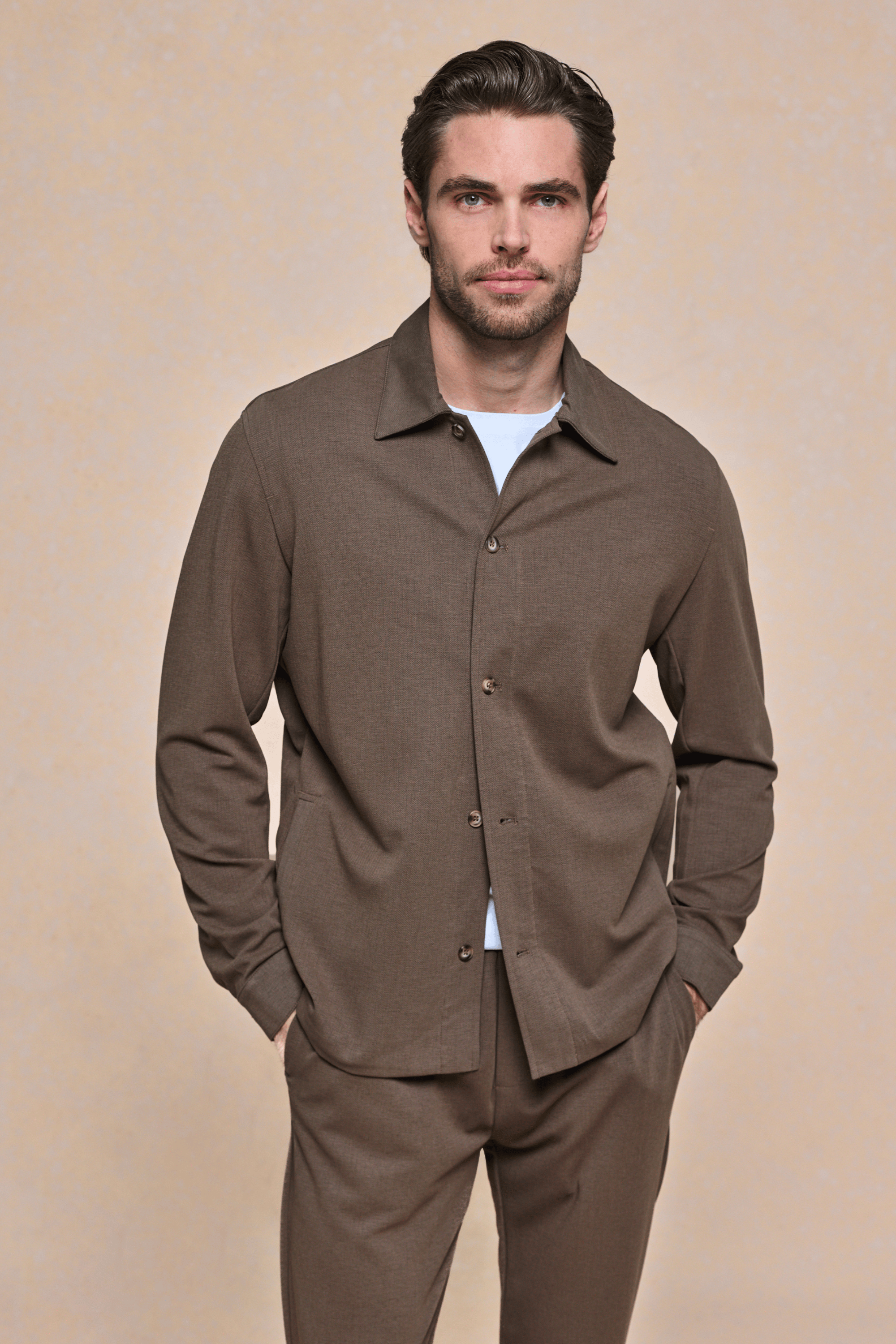 Man wearing a brown Geneva Textured Overshirt with a sharp collar, faux horn buttons, and matching trousers.