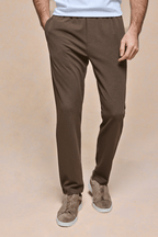 Men's brown textured tapered trousers with an elasticated waistband, side pockets, and a clean tailored fit.