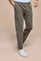 Men's Geneva Khaki Textured Tapered Trouser with elasticated waistband and side pockets, paired with white sneakers.