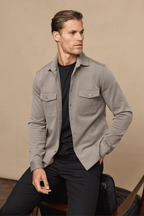 Man in beige/brown Jacques Textured Overshirt with twin chest pockets over a black t-shirt and trousers.
