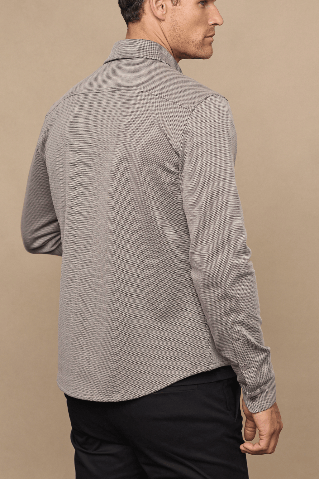 Man wearing a beige/brown textured Jacques Overshirt with pearlescent buttons and a classic collar.