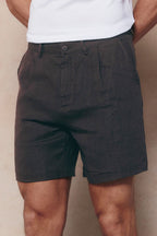 Brown Javier pleated waistband linen shorts with belt loops and side pockets.