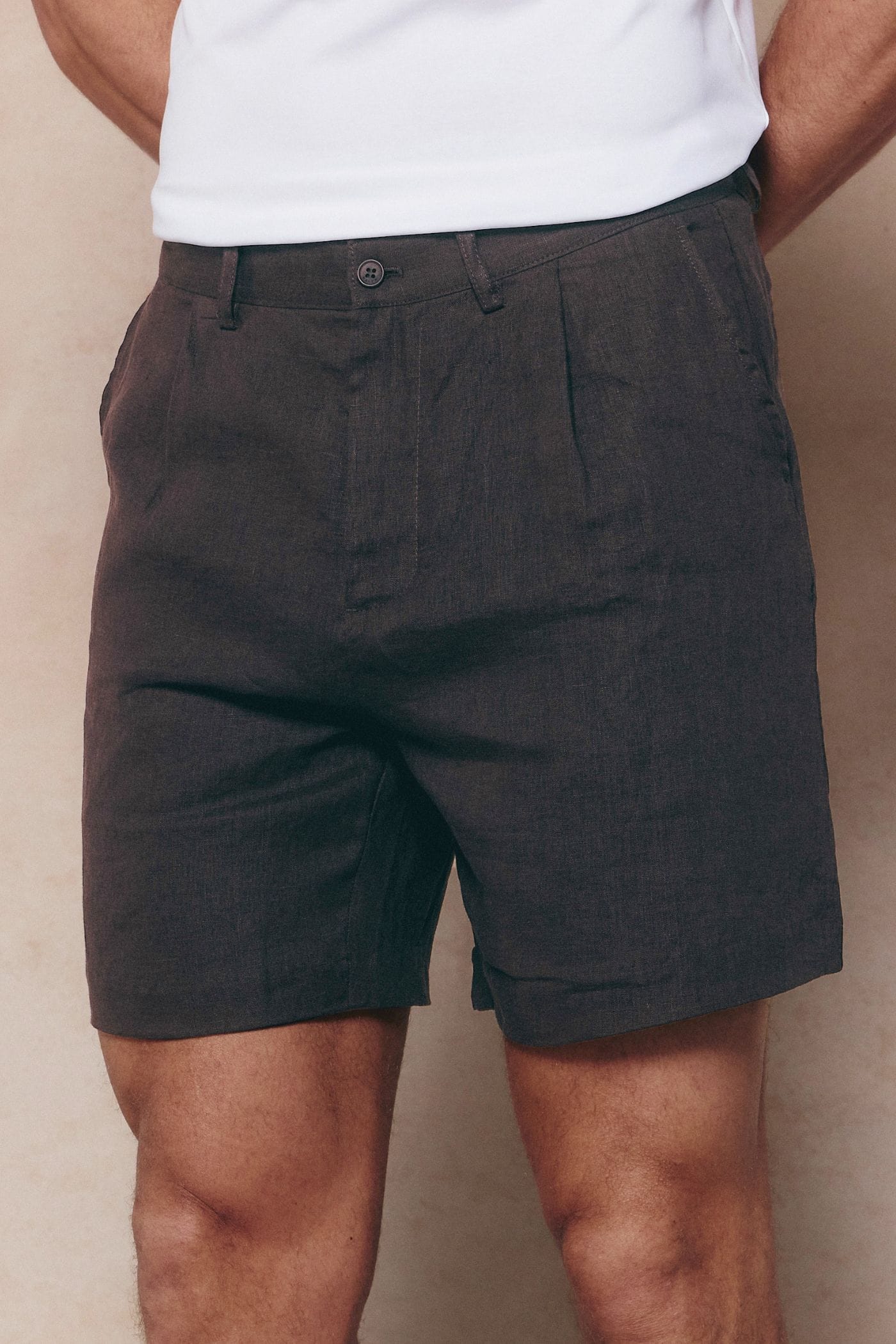 Brown Javier pleated waistband linen shorts with belt loops and side pockets.