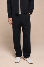 Black Julien Relaxed Panelled Trousers with straight fit, subtle top-stitched panels, and side entry pockets.