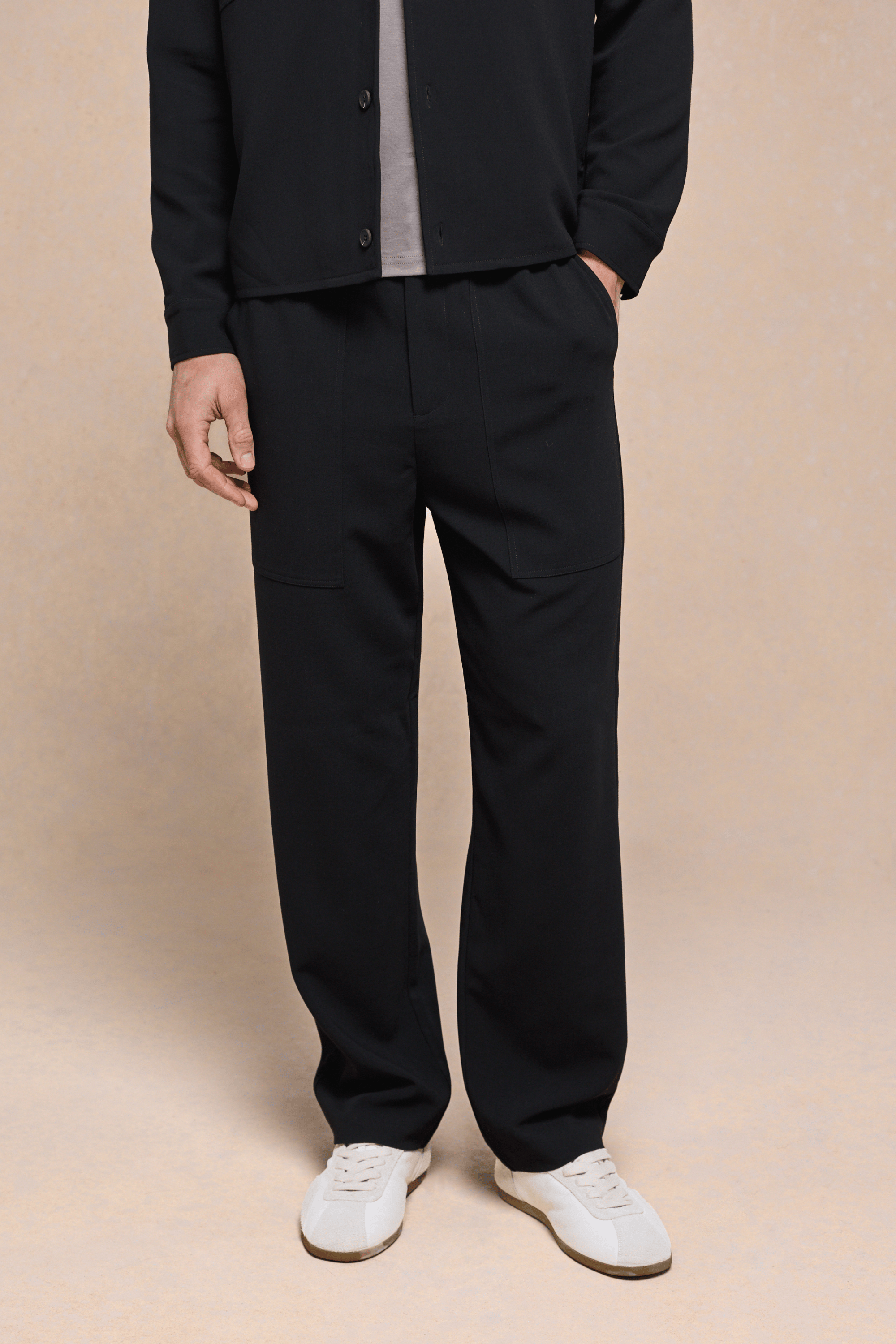 Black Julien Relaxed Panelled Trousers with straight fit, subtle top-stitched panels, and side entry pockets.