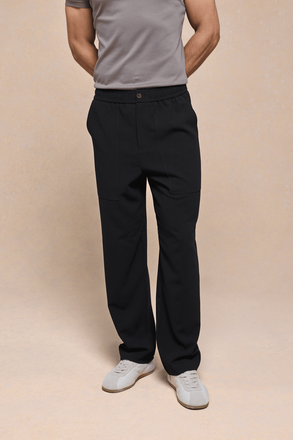 Black Julien Relaxed Panelled Trousers with straight fit, top-stitched panels, side pockets, and button fastening.
