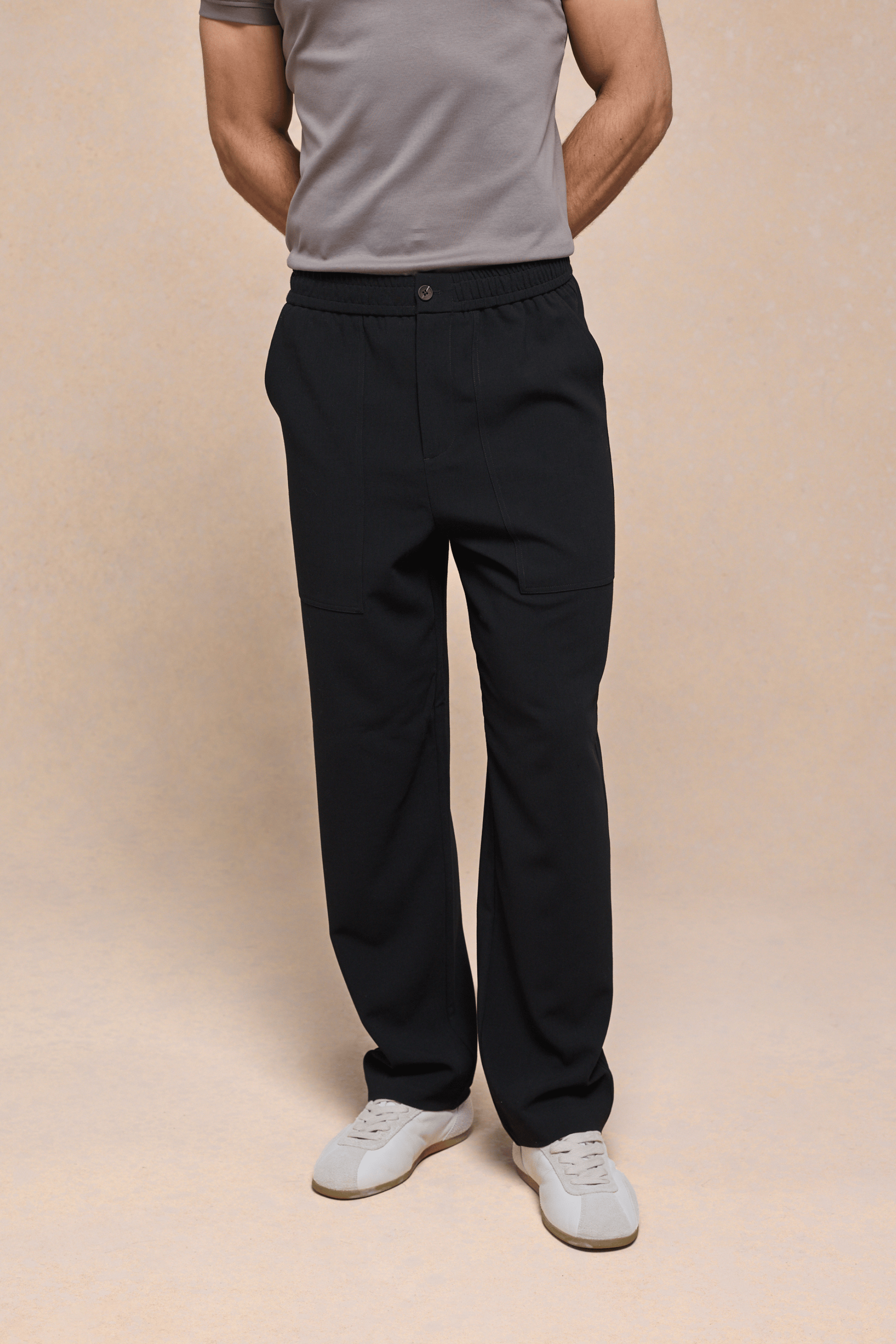 Black Julien Relaxed Panelled Trousers with straight fit, top-stitched panels, side pockets, and button fastening.