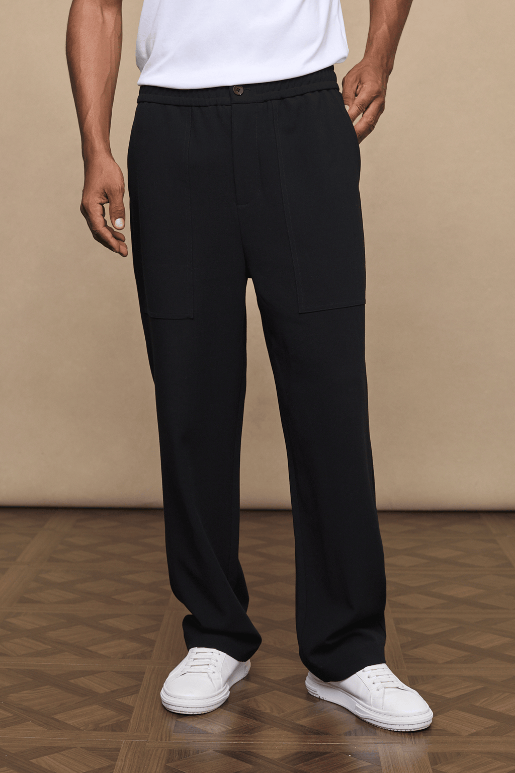Black Julien relaxed panelled trousers with a straight fit, subtle top-stitched panels, and side pockets.