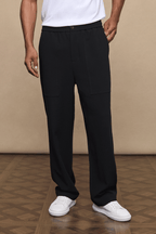 Black Julien relaxed panelled trousers with a straight fit, subtle top-stitched panels, and side pockets.