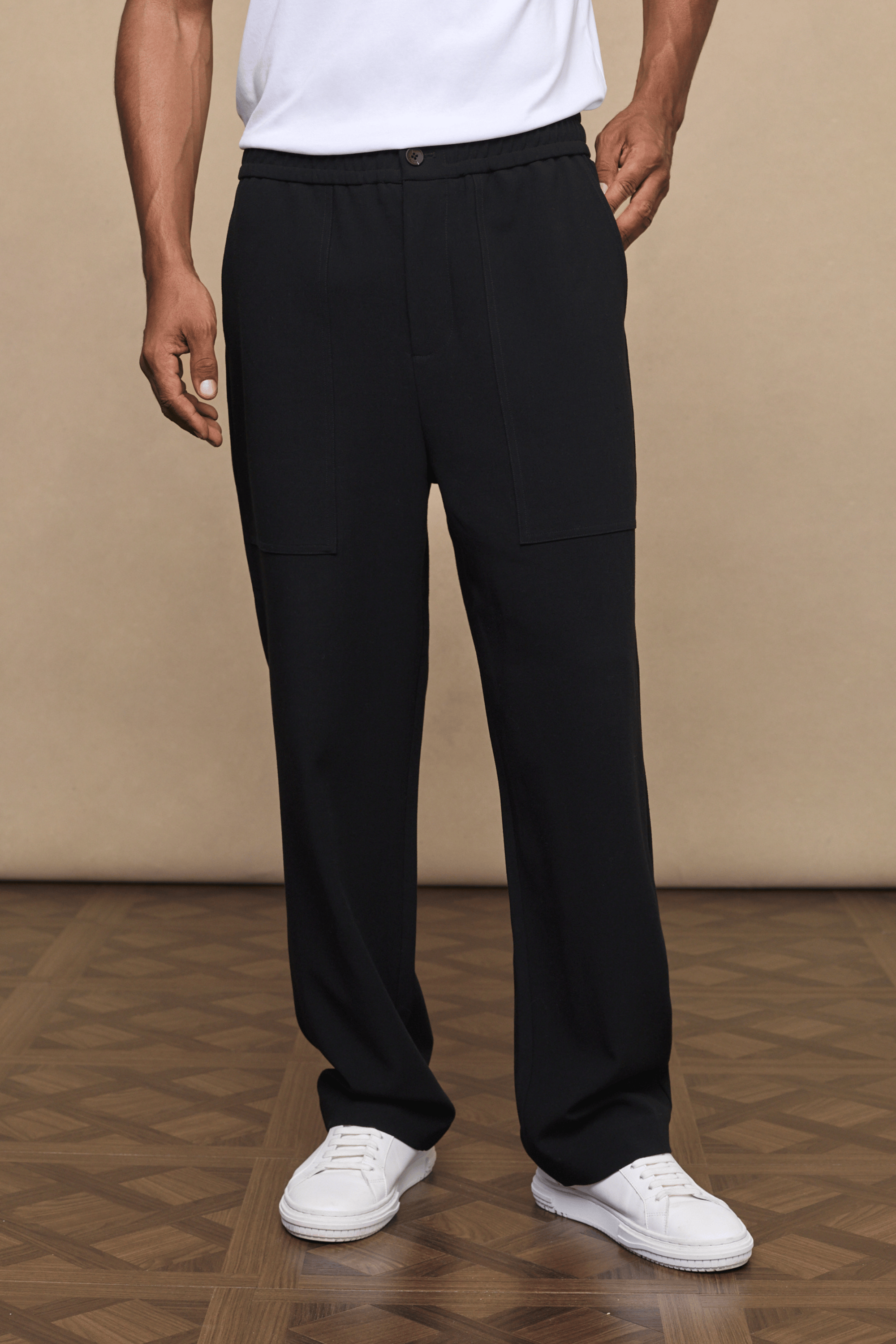 Black Julien relaxed panelled trousers with a straight fit, subtle top-stitched panels, and side pockets.