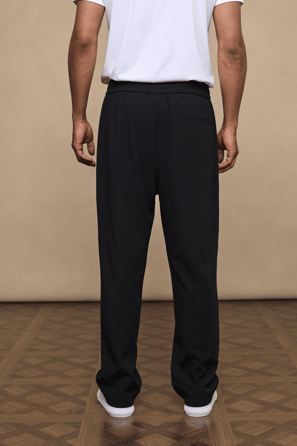 Black Julien relaxed panelled trousers with a straight fit, subtle top-stitched detailing, and elasticated waist.