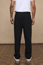 Black Julien relaxed panelled trousers with a straight fit, subtle top-stitched detailing, and elasticated waist.